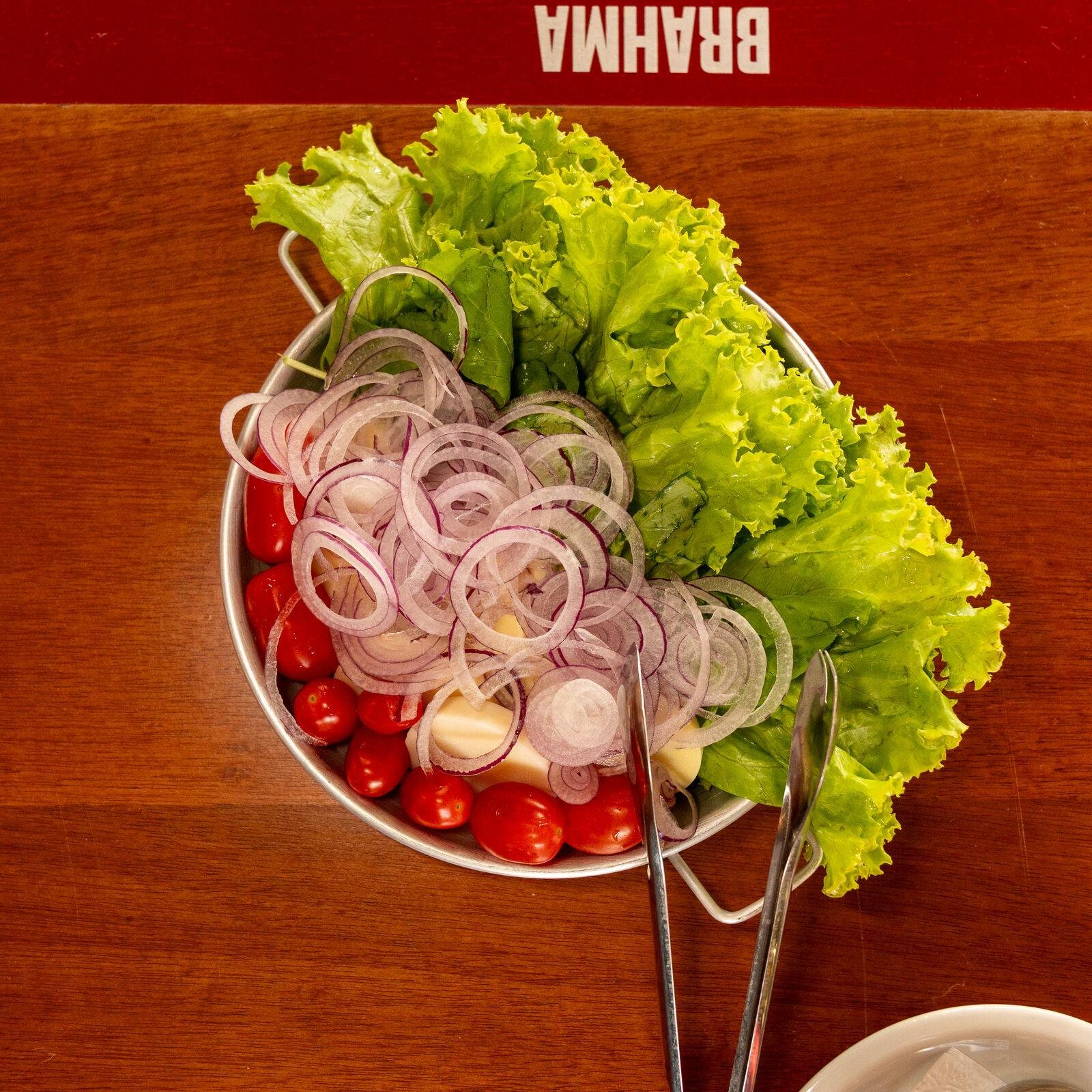 Salada de folhas, tomate-cereja e cebola roxa